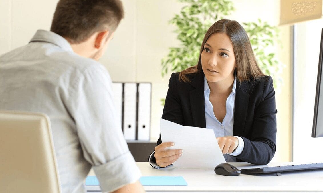 A woman is interviewing a boy for an interview.