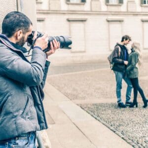 A man taking a picture of two women.