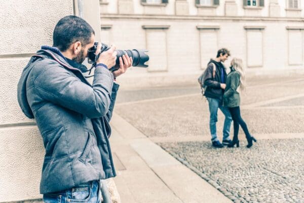 A man taking a picture of two women.